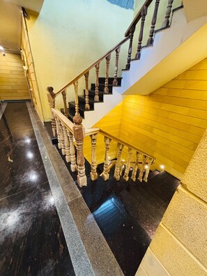 A staircase with wooden balusters and a yellow wall.