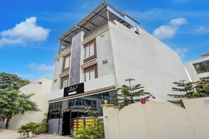 Un edificio moderno con escaparate y entrada protegida por un portón.