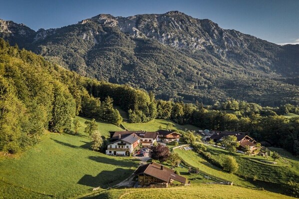A rural village with houses surrounded by green hills and a mountain in the background. - Untersberg "Jodlbauer" (Bad Reichenhall)