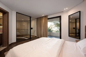 A modern bedroom with a large bed, a glass door leading to a balcony, and a large mirror on the wall. - Lovely Home at Elevens by Spacey #7 (cairo)