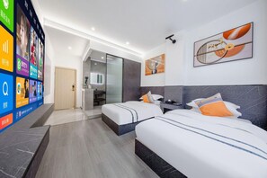 A hotel room with two beds, a bathroom, and a digital display wall. - Yuhao Business Hotel (Dali)