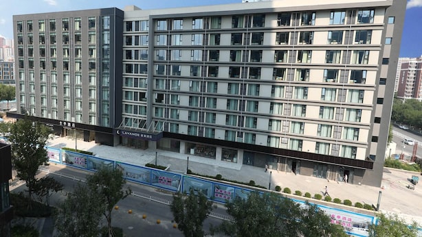A multi-story hotel with a modern design, featuring a flat roof and a uniform facade. - Lavande (Beijing)