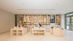 A modern retail store with wooden shelving and display tables. - Lavande (Beijing)