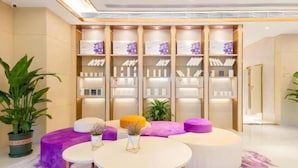 A modern interior with a reception desk, seating area, and a display of products. - Lavande (Beijing)