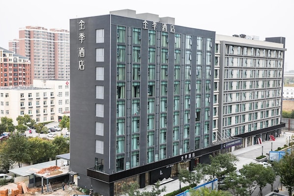 A modern hotel building with multiple floors, large windows, and a prominent entrance. - Lavande (Beijing)
