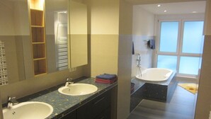 A modern bathroom with two sinks, a large mirror, and a separate shower area. - Rolf Bauer on the 1st floor (Konstanz)