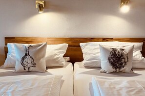 A hotel room with two beds, each with a white headboard and a pillow with a black animal print. - Alpenflair Holiday Apartment 102 (Oberstdorf)
