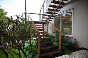A staircase with a glass enclosure leading to a modern interior. - Mastiff Select Riveria Resort, Igatpuri Road, Nashik (Nashik)