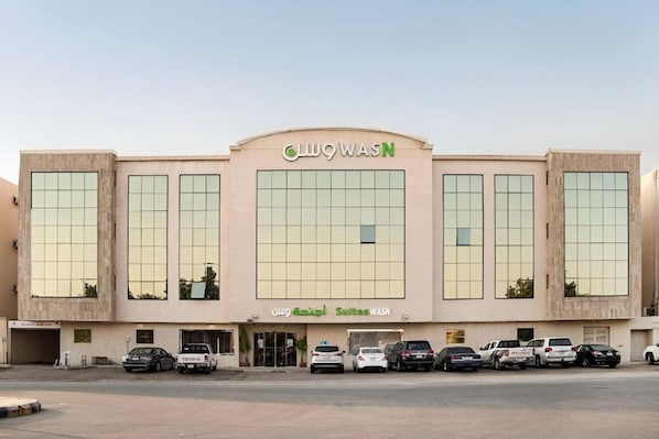 A building with a large central window and multiple smaller windows, labeled 'WASN' and 'WASN Suites.' - OYO 628 Wasan Suites (Riyadh)