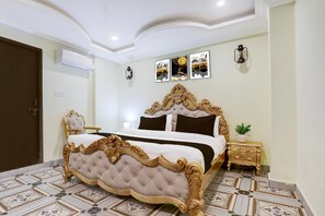 Ein Schlafzimmer mit einem großen Bett, einem Nachttisch, einer Wandlampe und einem gerahmten Bild über dem Bett.