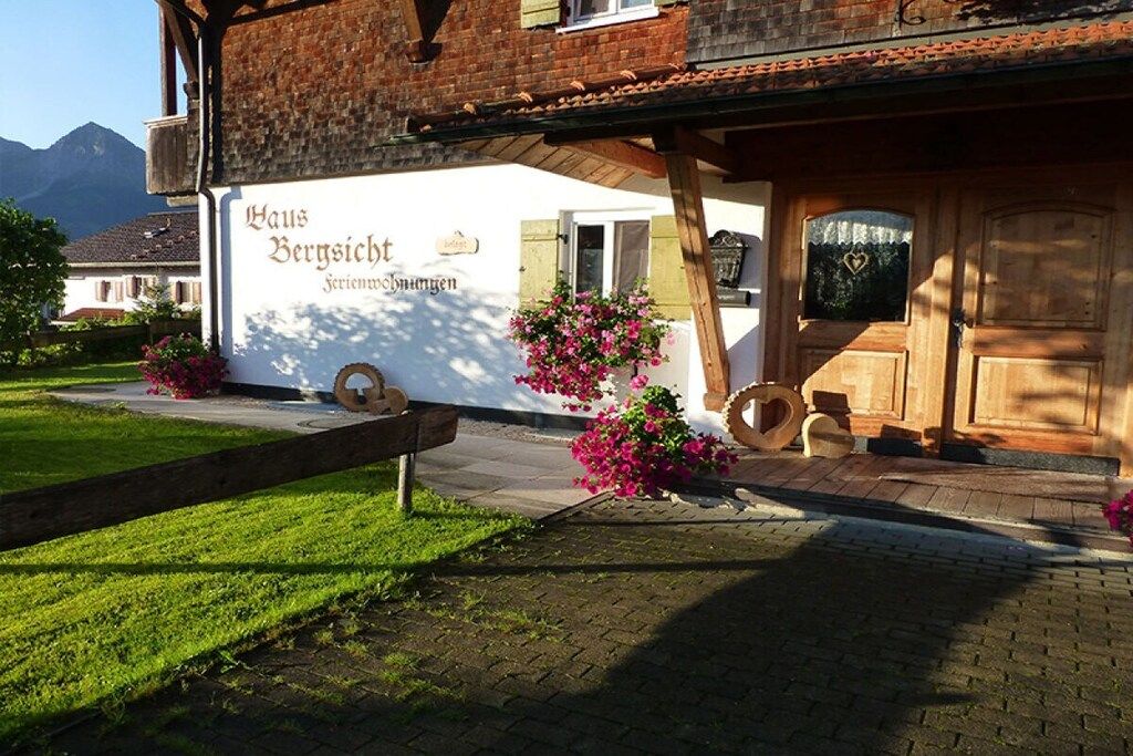 A traditional building with a sign that reads 'Haus Berschicht Ferienwohnungen.'