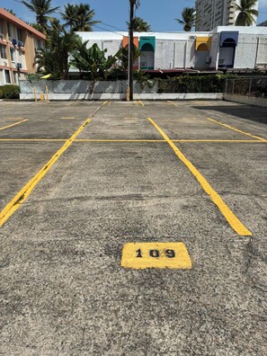 A parking lot with marked spaces and a number 109 sign. - Luxury beachfront apartment (Luquillo)