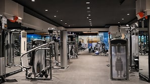 A gym with various exercise equipment, including weight machines and free weights.