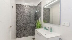 A modern bathroom with a shower, a sink, and a mirror. - Stunning Costa Adeje Villa: 3BD, Private Pool, Terrace & AC (Costa Adeje)