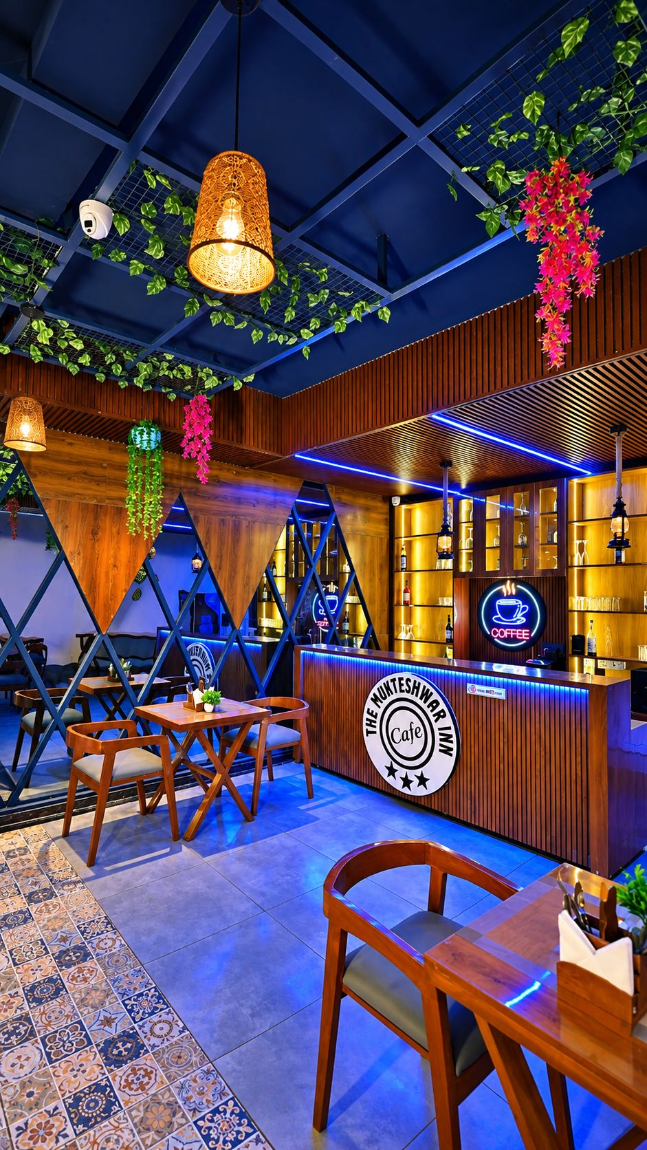 A cafe interior with wooden furniture, a counter with a neon sign, and hanging plants.