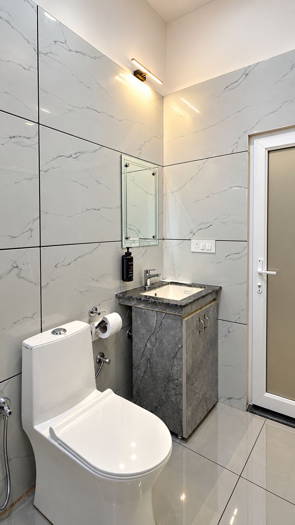 A modern bathroom with a toilet, sink, and shower.