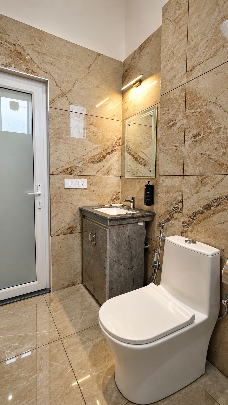 A modern bathroom with a toilet, sink, and mirror.