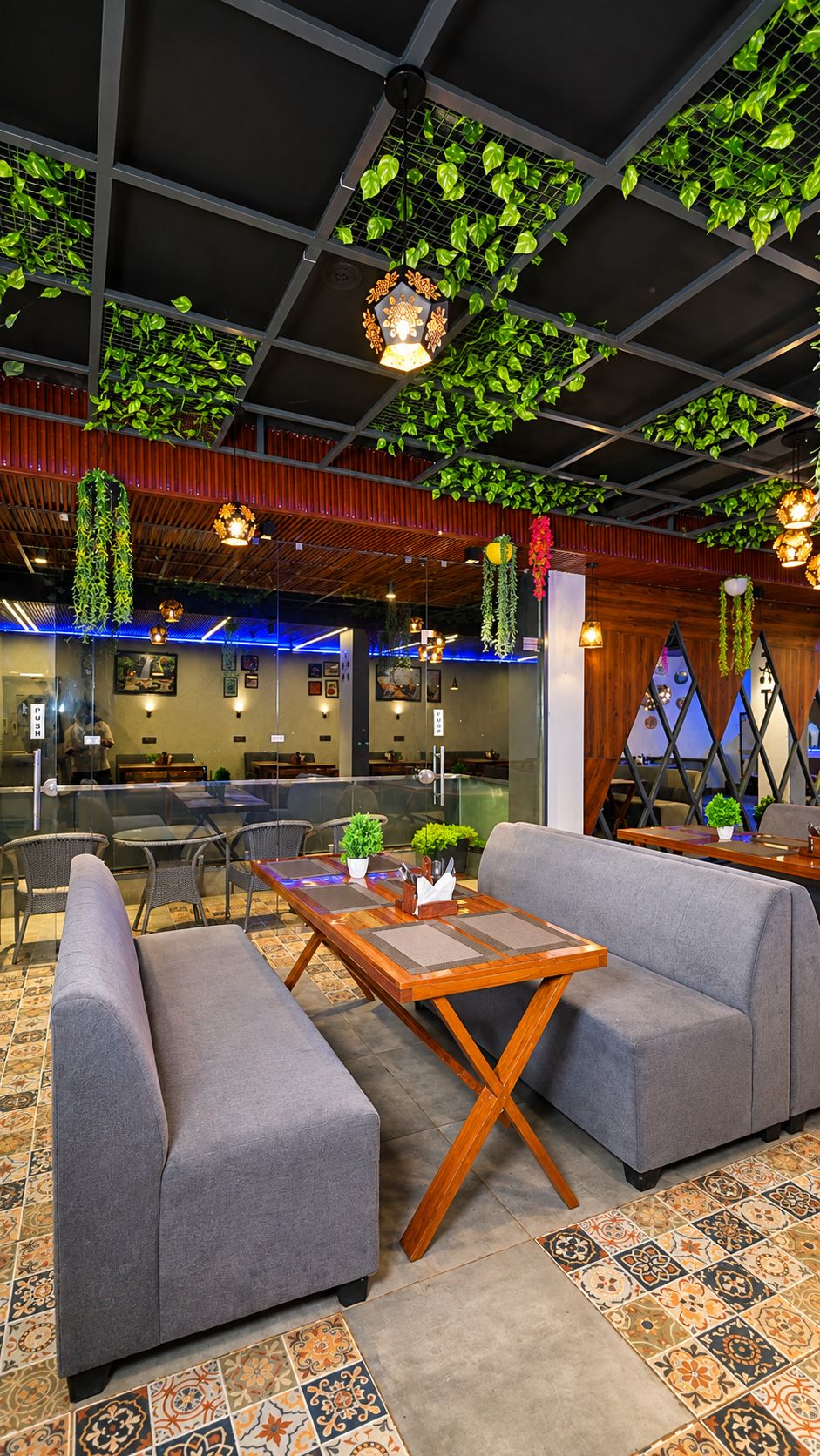 A modern lounge area with seating, a coffee table, and decorative plants.