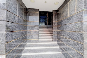 A staircase with marble walls and golden lines, leading to a dark interior. - Collection O Chidambaram Stadium (Chennai)
