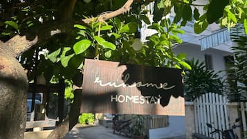 A sign with the text 'home' and 'HOMESTAY' indicating a homestay accommodation.