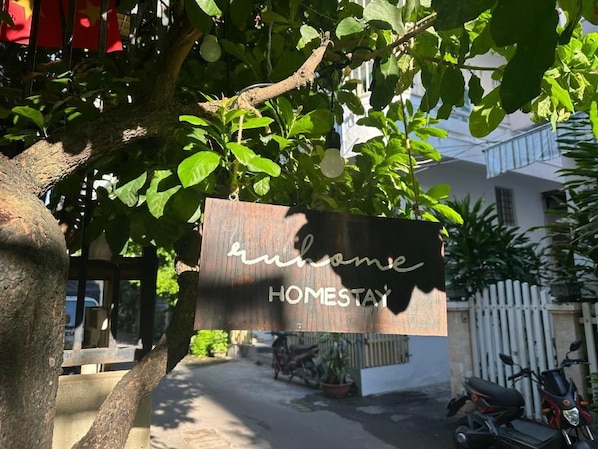 A sign with the text 'home' and 'HOMESTAY' indicating a homestay accommodation.