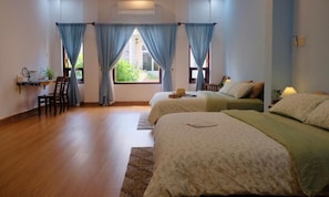 A hotel room with two beds, a desk, and a chair. - Ruhome Quy Nhon - Central & Near Beach (Quy Nhon)