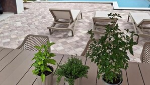 An outdoor seating area with a pool in the background. - Villa One (Jastrebarsko)