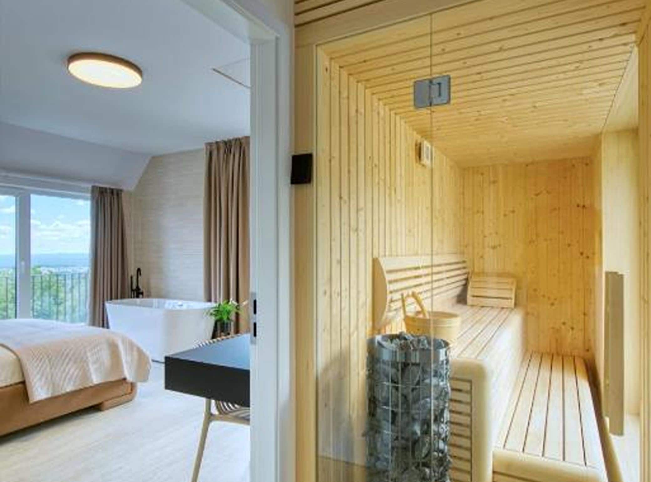 A modern hotel room with a large bed, a desk, and a view of the outdoors.