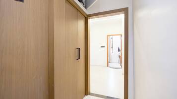 A hallway with a wooden door marked '202' and a white wall.