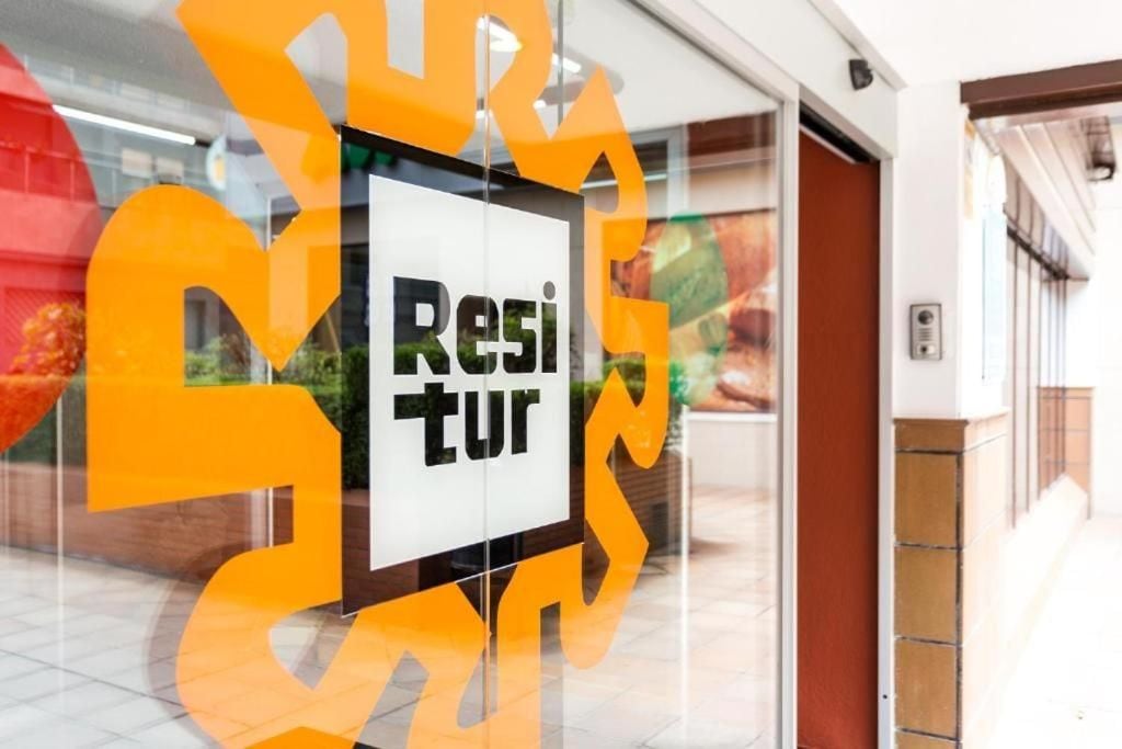 A sign with the word 'Resi' partially visible, suggesting a location related to residence or lodging.