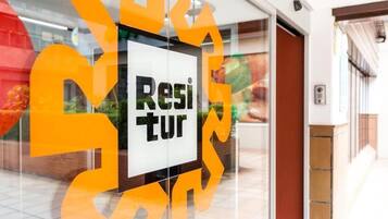 A sign with the word 'Resi' partially visible, suggesting a location related to residence or lodging.