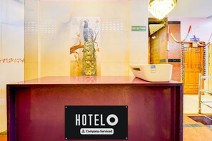 A reception desk with a sign reading 'HOTEL' and 'Company-Serviced'. - Hotel O Manali Crossway Chennai (Chennai)