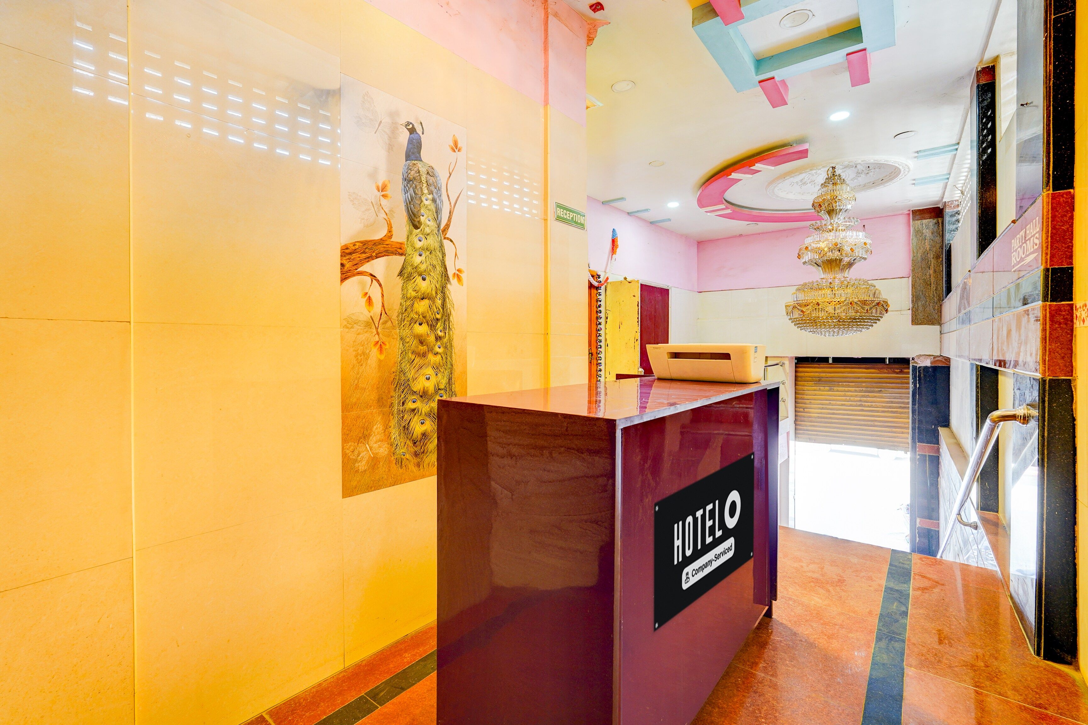 A hotel reception desk with a sign indicating 'HOTEL' and 'RECEPTION'.