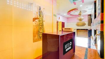 A hotel reception desk with a sign indicating 'HOTEL' and 'RECEPTION'.