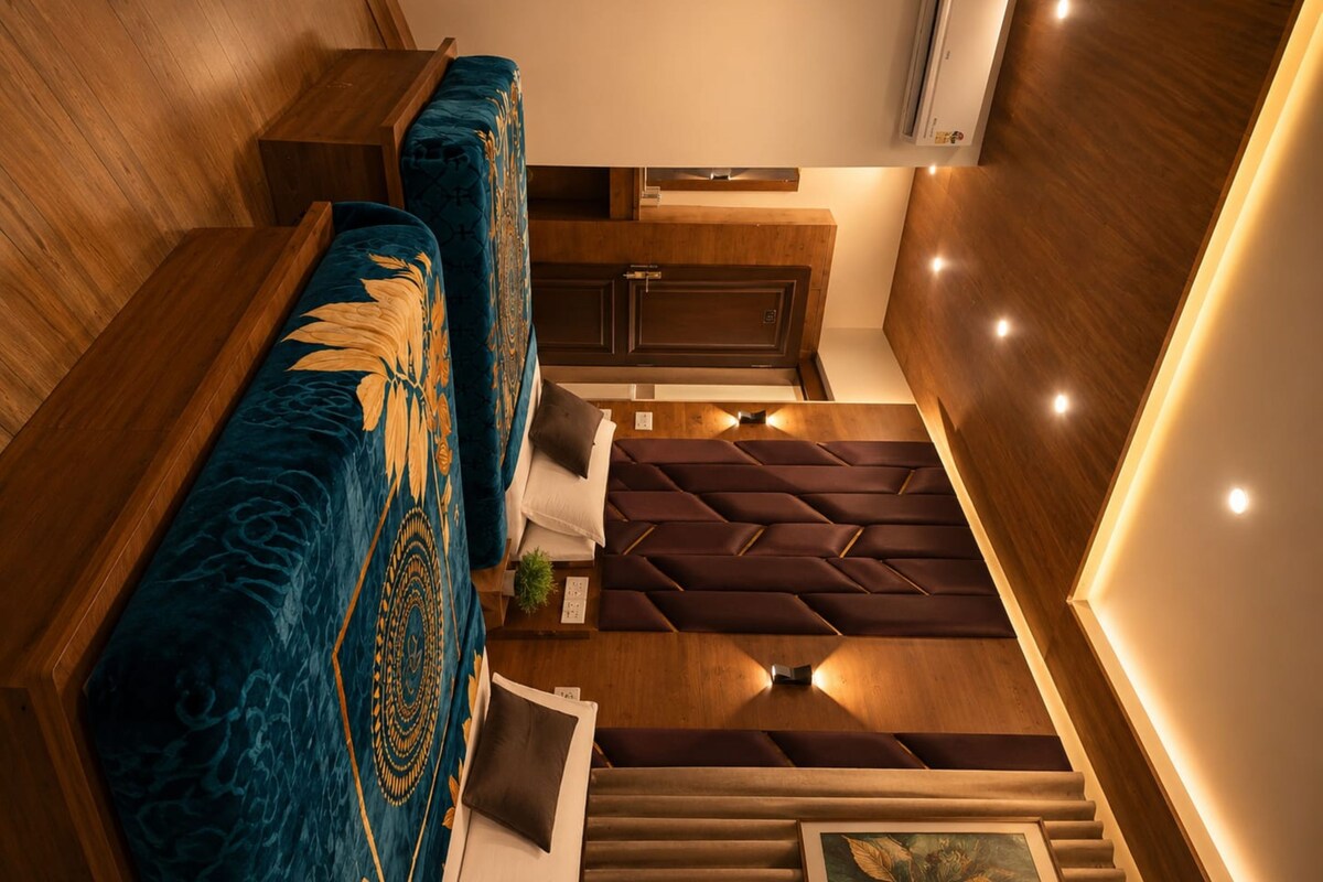 A modern interior with a sofa, a cushioned bench, and a staircase.