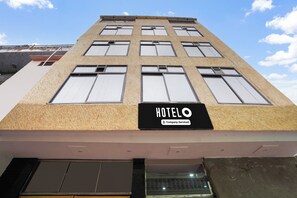 A hotel building with a sign indicating it is company-serviced.