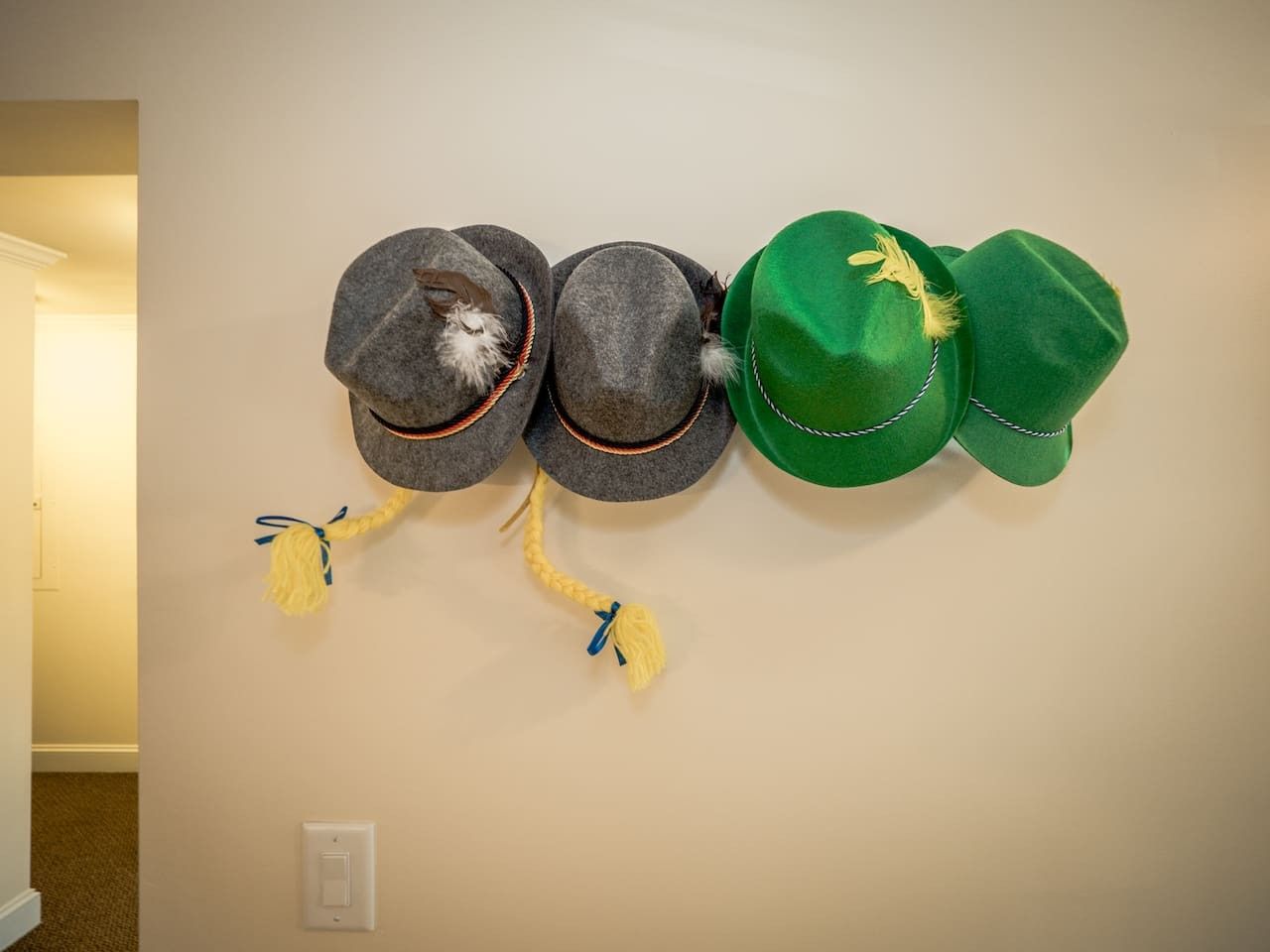 A wall-mounted display of hats with tassels.