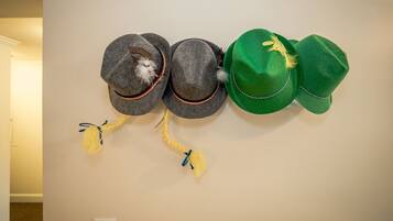 A wall-mounted display of hats with tassels.