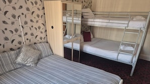A room with a bunk bed, a single bed, and a wardrobe with a mirror. - White Moon Hotel (Blackpool)