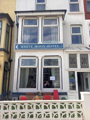 A two-story building with a sign reading 'WHITE MOON HOTEL.' - White Moon Hotel (Blackpool)