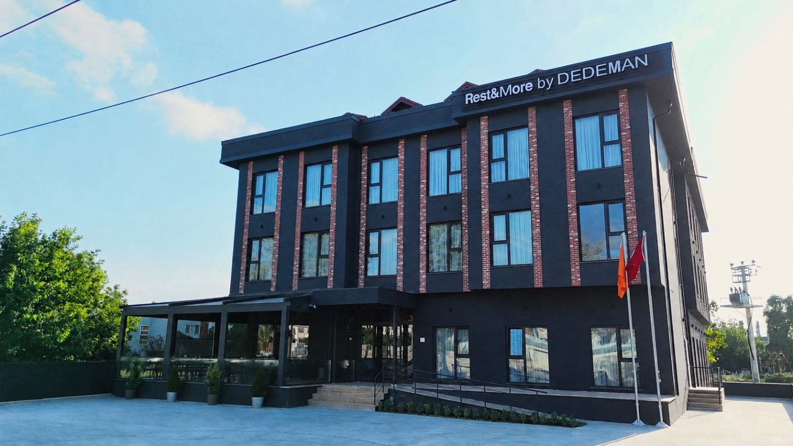 A modern building with a sign reading 'Rest&More by DEDEMAN'.