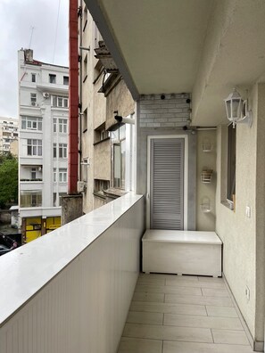 A narrow balcony with a white railing, a door, and a small bench. - The Bright IN Unirii Square next to the Old Town (București)