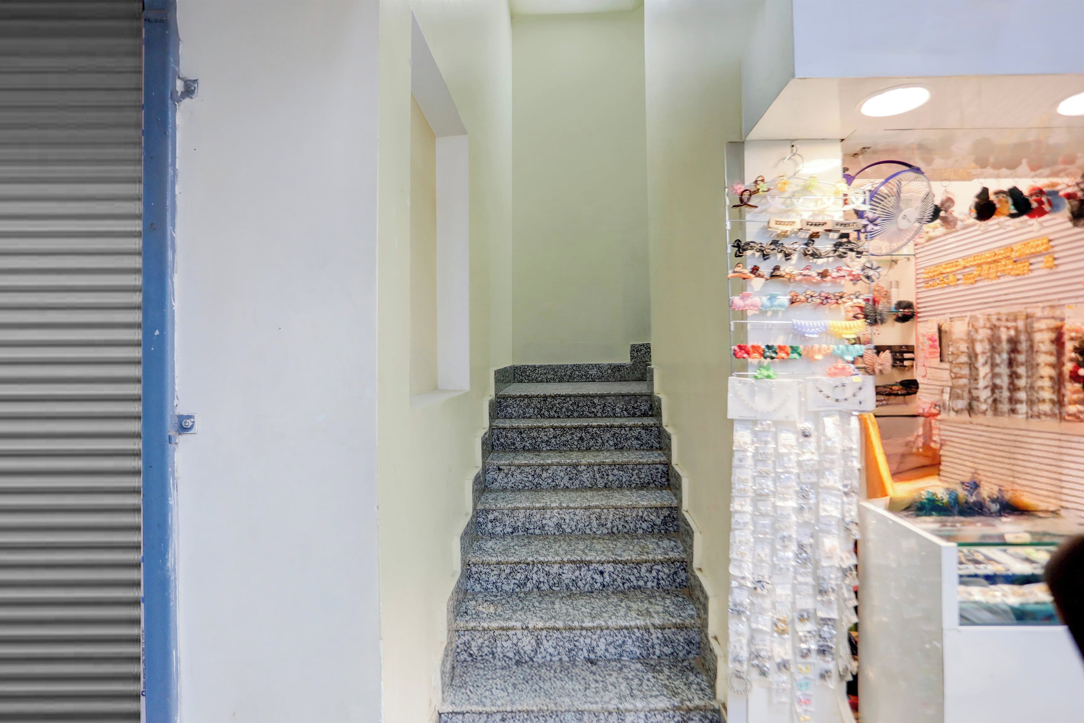 A staircase leading to a store with various items on display.
