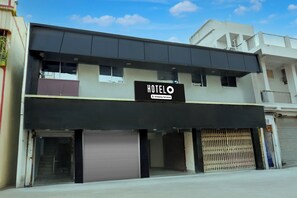 A two-story building with a sign reading 'HOTEL' and 'Company Serviced.' - Hotel O Hanuman Nagar Kankarbagh (Patna)