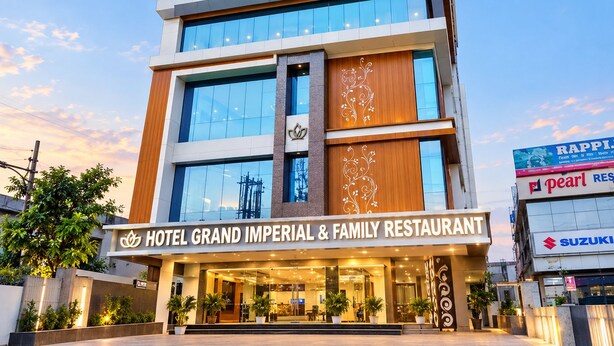 Een meerhoog hotel met een opvallend bord waarop staat: 'HOTEL GRAND IMPERIAL & FAMILY RESTAURANT'.