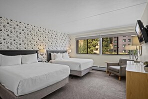A hotel room with two beds, a desk, a chair, and a TV. - Beaver Run - Breck Blast|Ski Views|Pool&Hot Tubs (Breckenridge)