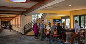 A bar area with wooden chairs and a counter, a staircase, and a sign that reads 'Beaver Run.' - Beaver Run-Ski-In/Out| Winter Retreat| Heated Pool (Breckenridge)