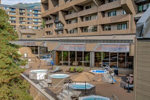 A hotel with multiple hot tubs and outdoor seating areas. - Beaver Run -Our Happy Place | Luxury Suite (Breckenridge)