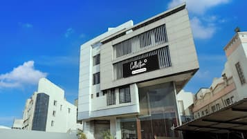 Un bâtiment moderne avec une enseigne indiquant : « Société de recouvrement de créances – Services offerts ».