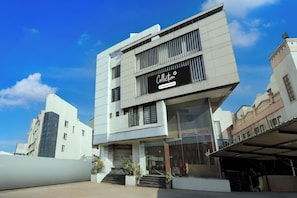 A modern building with a sign that reads 'Collection Company-Serviced.'